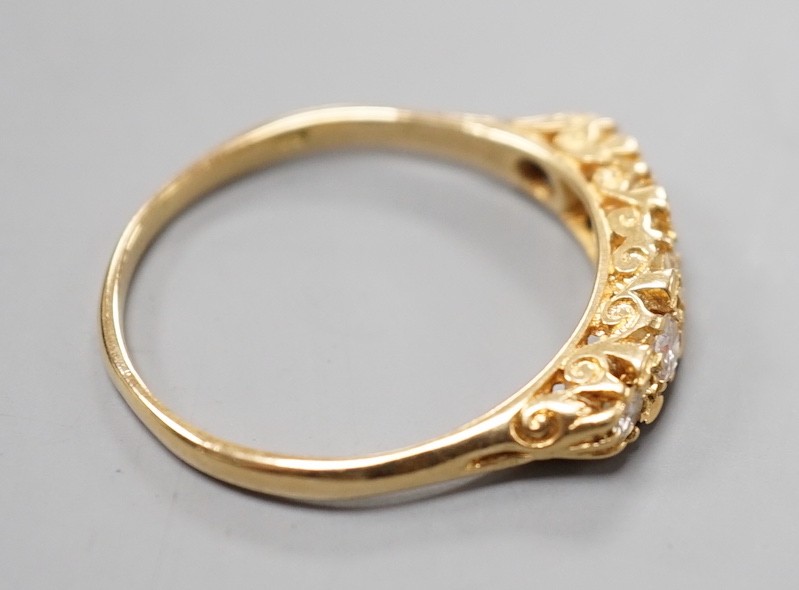A modern 18ct gold and graduated five stone diamond set half hoop ring, size T, gross weight 3.8 grams.